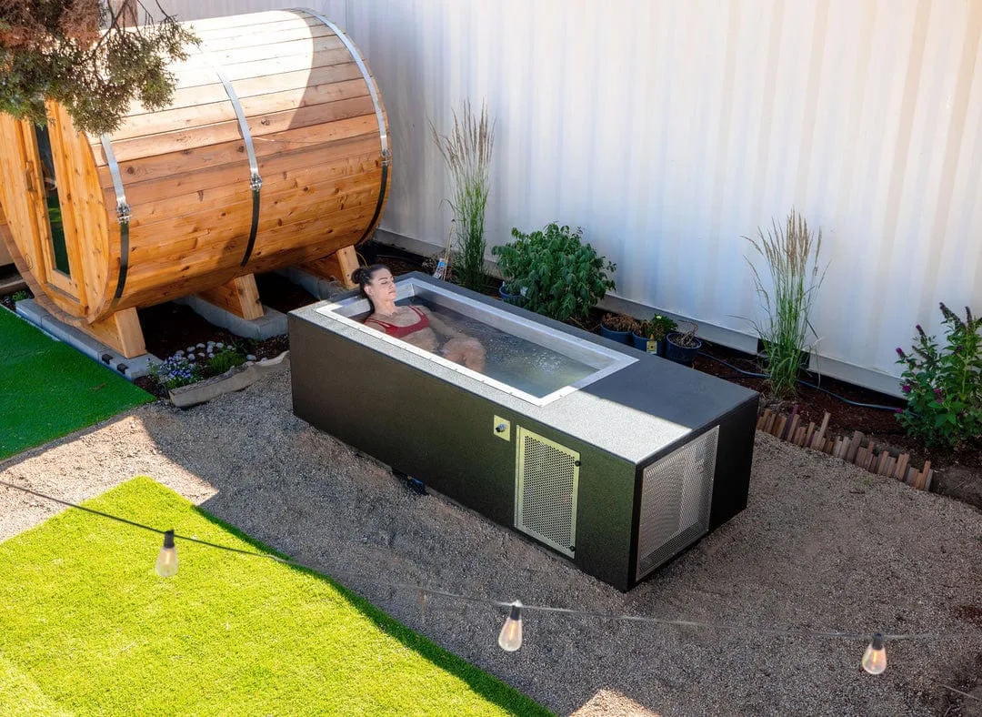 A hot tub in the middle of a yard.