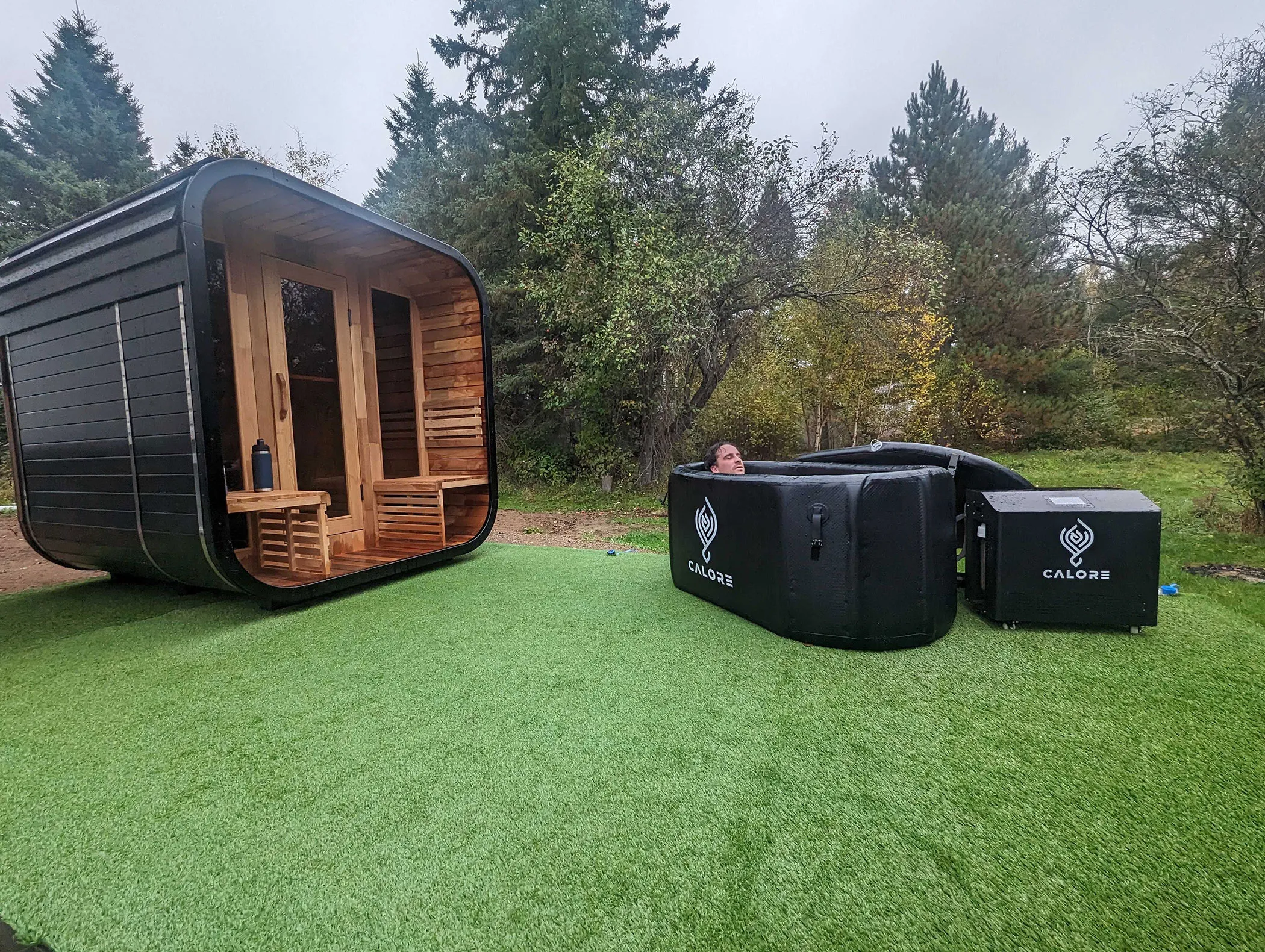 A couple of hot tubs sitting on top of a lush green field.